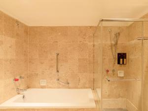 a bathroom with a bath tub and a shower at Rhyme&Time Hotel in Kaohsiung +31 photos