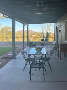 a patio with chairs and a table and a grill at The Tortolita House in Tucson