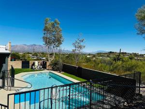 a swimming pool in the backyard of a house at The Tortolita House in Tucson