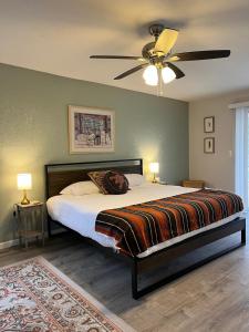 a bedroom with a bed with a ceiling fan at The Tortolita House in Tucson +37 photos