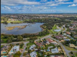 an aerial view of a suburb with a lake at The Lakeside Retreat in Perth