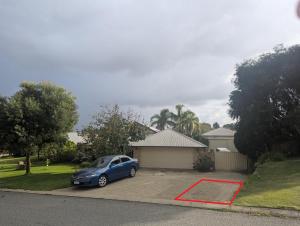 a blue car parked in front of a house at The Lakeside Retreat in Perth