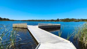 a wooden dock in the middle of a lake at The Lakeside Retreat in Perth