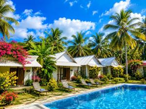 a resort with a swimming pool and palm trees at The Ramp Udawalawe in Udawalawe