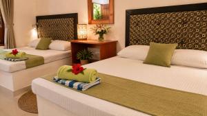 a hotel room with two beds with towels on them at The Ramp Udawalawe in Udawalawe +42 photos