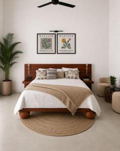 a bedroom with a large bed and a ceiling fan at Casa Dega in Balapitiya