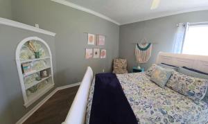 a bedroom with a bed and a chair in it at The Little House at EVOO in Cookeville
