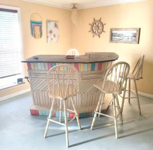 a bar with two chairs and a table in a room at The Little House at EVOO in Cookeville