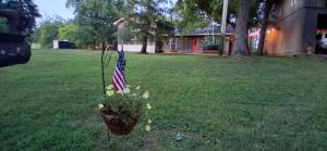 a flower pot with an american flag in a yard at The Little House at EVOO in Cookeville