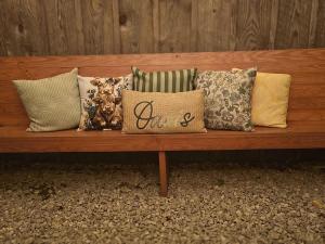 a wooden bench with a bunch of pillows on it at The Little House at EVOO in Cookeville +46 photos