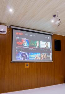 a projection screen on a wall in a room at Rock View Cottage in Ella