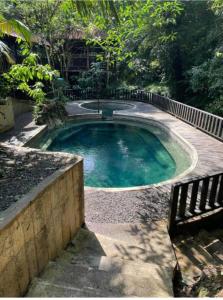 a small swimming pool with a fence around it at Posada El Encanto in Nuquí