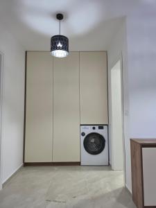 a laundry room with a washer and a washing machine at Amd Ville Apartments in Dobra Voda