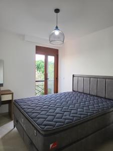 a large bed in a room with a window at Amd Ville Apartments in Dobra Voda +19 photos