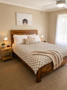 a bedroom with a large bed and a window at Coastal Cottage in Saint Leonards