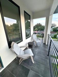 a balcony with two chairs and windows on a house at Tampa Lounge in Ybor in Tampa