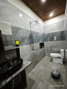 a bathroom with a sink and a toilet and a shower at Aeronest Villa "your new escape" in Udaipur +5 photos
