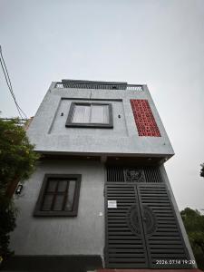 a building with two windows on the side of it at Aeronest Villa "your new escape" in Udaipur