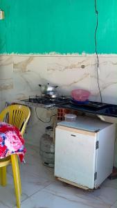 a kitchen with a stove and a table and chairs at MT laser in São José da Coroa Grande