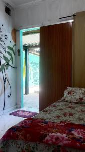 a bedroom with a bed and an open door at MT laser in São José da Coroa Grande +14 photos