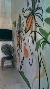 a wall with a painting of a flower on it at MT laser in São José da Coroa Grande