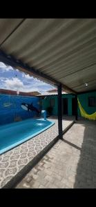 a swimming pool with a painting on the wall at MT laser in São José da Coroa Grande