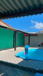 a playground with a blue slide in a sandbox at MT laser in São José da Coroa Grande