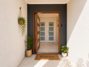 an open door to a hallway with potted plants at Guest House near theme parks in Pimpama +5 photos
