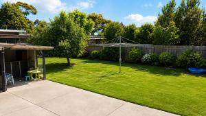 a yard with a tent in the grass at Coastal Cottage in Saint Leonards