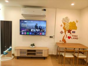 a living room with a flat screen tv on the wall at ลุงไซยเดอะแคมป์ in Ban Wang Hin Ngon +42 photos
