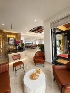 a lobby with couches and chairs and a table at Lux Meris Hotel in Nhượng Bạn