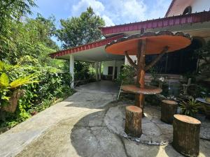 a wooden bench sitting in front of a house at Wobbless Wonder Homestay in Bandar Seri Begawan