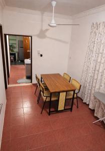 a dining room with a wooden table and chairs at Wobbless Wonder Homestay in Bandar Seri Begawan
