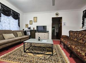 a living room with a couch and a coffee table at Wobbless Wonder Homestay in Bandar Seri Begawan