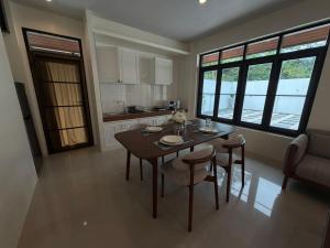 a kitchen with a table and chairs in a room at Villa Tara Khaolak in Khao Lak +19 photos