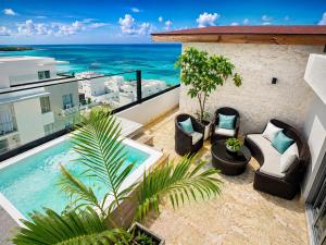 an ocean view from the balcony of a hotel with a swimming pool at Luxurious Ocean View Penthouse in Boca Chica