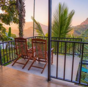 two chairs on a balcony with a view of the mountains at Rock View Cottage in Ella +17 photos
