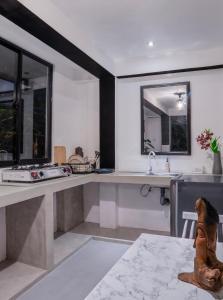 a kitchen with two sinks and two windows at Rock View Cottage in Ella