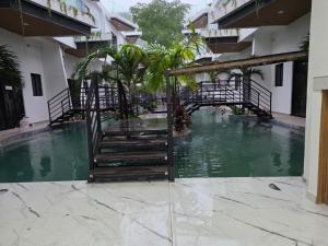 a pool in the courtyard of a building at Hotel Herradura in Herradura