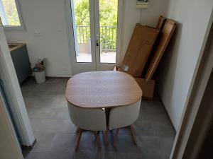 a wooden table and a chair in a room at Blue Dream in Morne Blanc