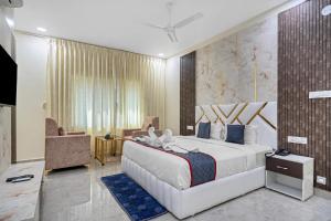 a bedroom with a large bed in a room at Hotel Skyland Khammam in Khammam