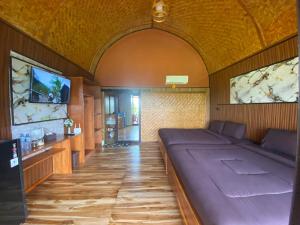 a room with a large bed in a room at Angghy Garden Tetebatu in Tetebatu