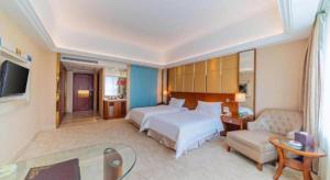 a large hotel room with two beds and a couch at Regency Hotel in Dongguan +76 photos