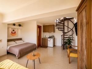 a bedroom with a bed and a spiral staircase at Studio Acropolis Serres Parking EV Next to Center in Serres +48 photos