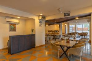 a dining room with a table and chairs at Hotel Carnival The Goa in Pilerne