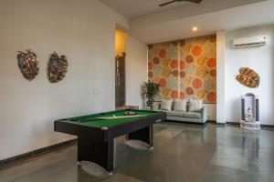 a room with a pool table and a couch at Hotel Carnival The Goa in Pilerne