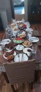 a wooden table with plates of food on it at Fafo in Zhabeshi