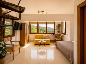 a bedroom with a bed and a couch and a chair at Studio Acropolis Serres Parking EV Next to Center in Serres