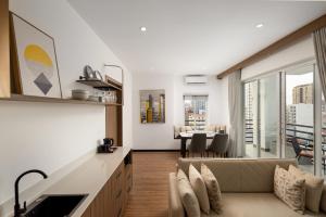 a living room with a couch and a table at WH Hotel 310 in Phnom Penh