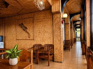 a dining room with wooden chairs and a table at LIV Coron in Coron